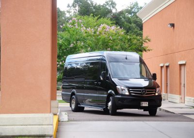 A limo shuttle parked in front of a building