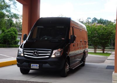 A limo shuttle parked in front of a building